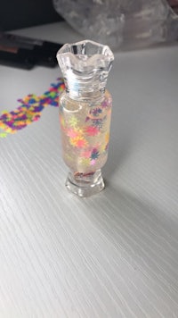 a small glass bottle with confetti in it