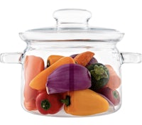 a glass pot filled with vegetables