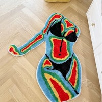 a colorful bathroom rug with a woman in a bikini